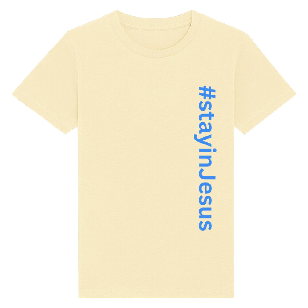 christliches T-Shirt für Kinder mit einem Unisex-Schnitt in hellgelb aus 100 % Bio-Baumwolle senkrecht auf der rechten Seite steht "#stay in Jesus". Erhältlich in den Größen 98/104 bis 152/164